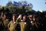 Soldiers of the Netzah Yehuda Haredi infantry battalion in green ourits during swearing in