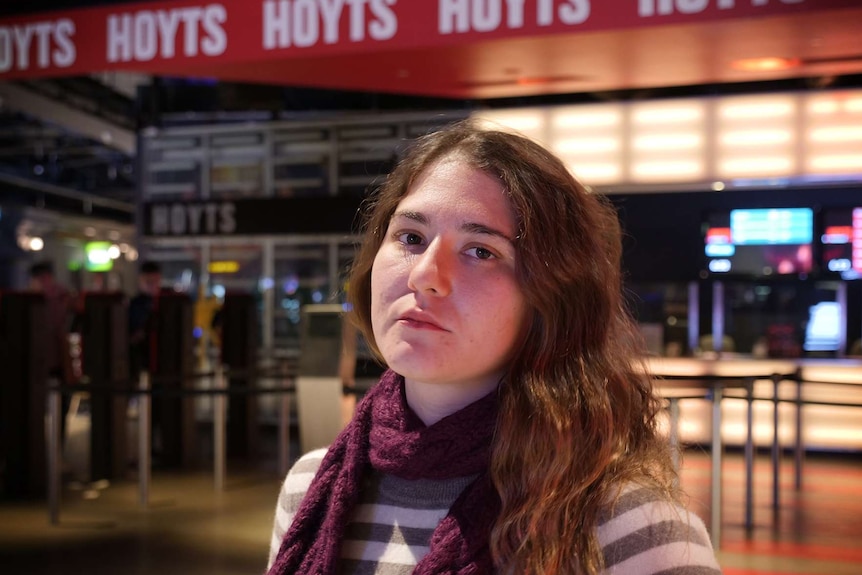Alexandra McKenzie stands in front of a Hoyts Cinema