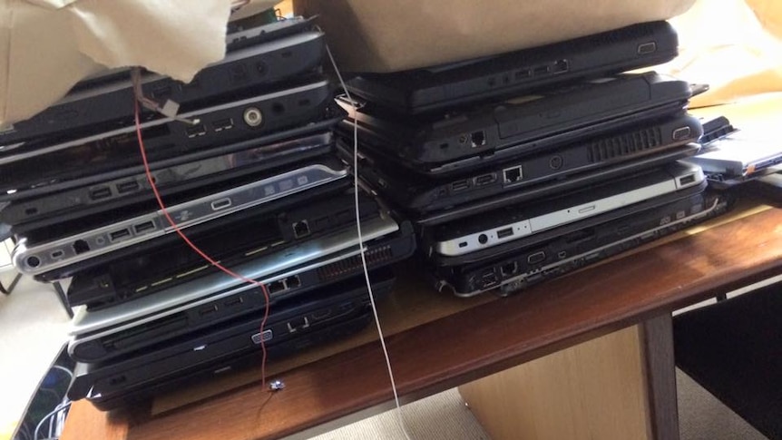 A stack of 13 laptops