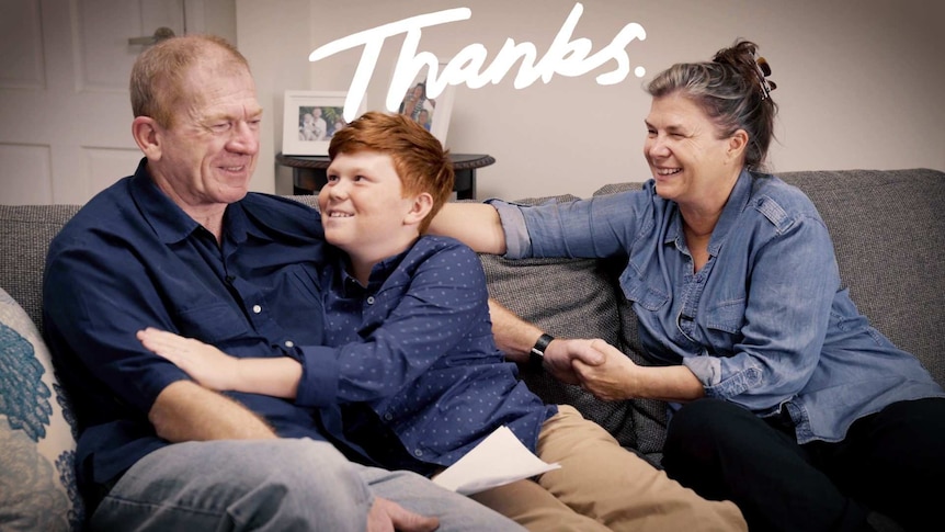 Jacob James sitting on the couch with his dad and mum with the title: Thanks to depict family life when your father has dementia