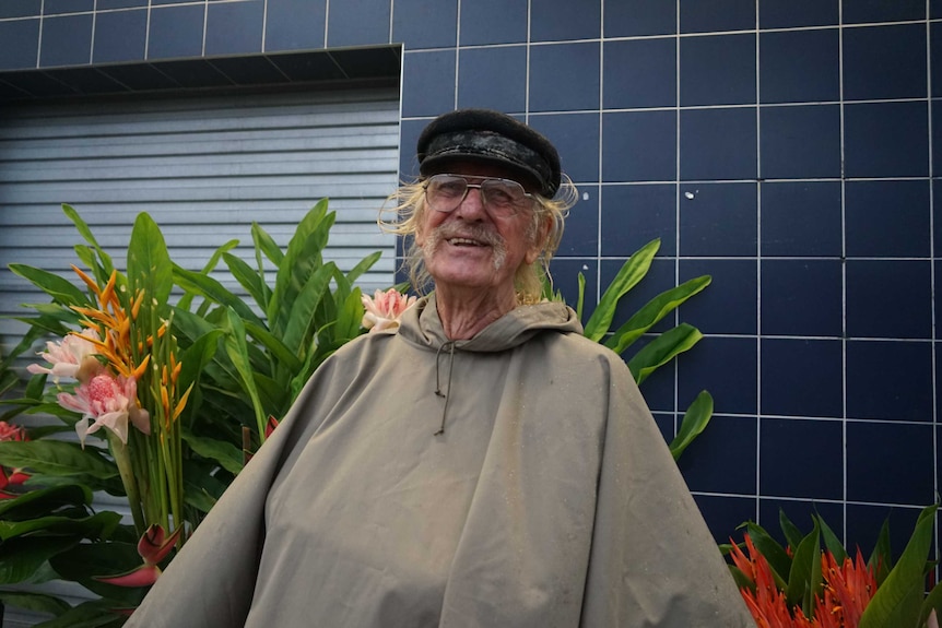 A man sits with his flowers