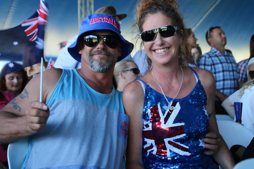 C.ouple Brad and Jules Lampert celebrate Australia Day at the largest citizenship ceremony in WA. Brad waves an Australian flag.