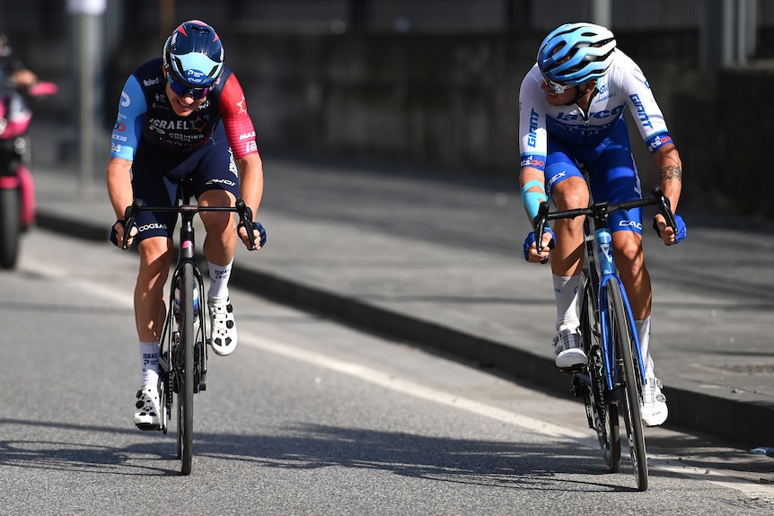 Alessandro De Marchi looks at Simon Clarke as they ride together on stage six of the Giro d'Italia.