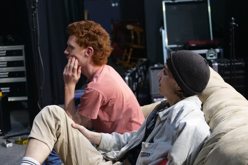 Two young men sitting on a couch.