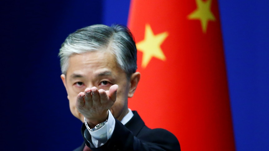 Chinese foreign ministry spokesman Wang Wenbin gestures in a news conference in Beijing.