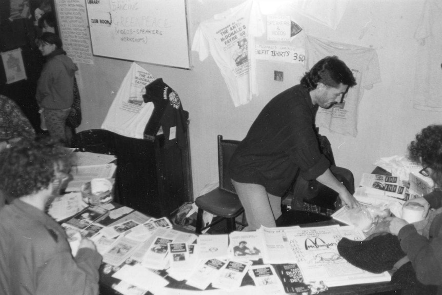 A black and white photo of a man in an office