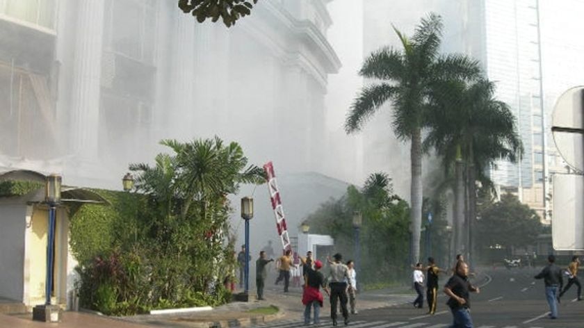 Panic: People run following the blast at the Ritz-Carlton Hotel.