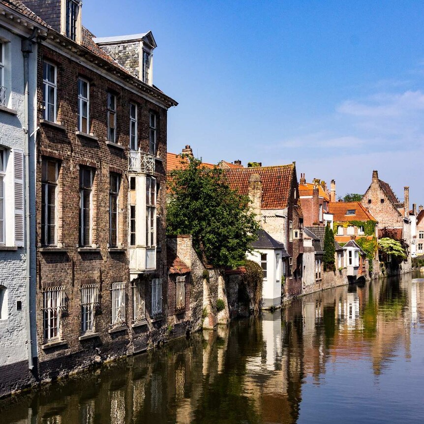 Canal in Bruges where the water comes right up to the edge of the buildings and reflected in it.