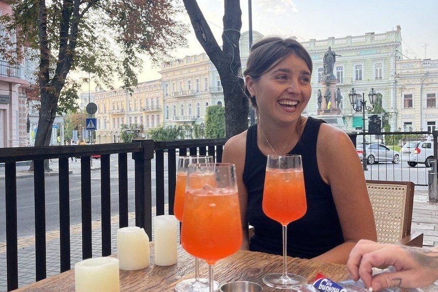 A woman drinks at an Odesa restaurant.