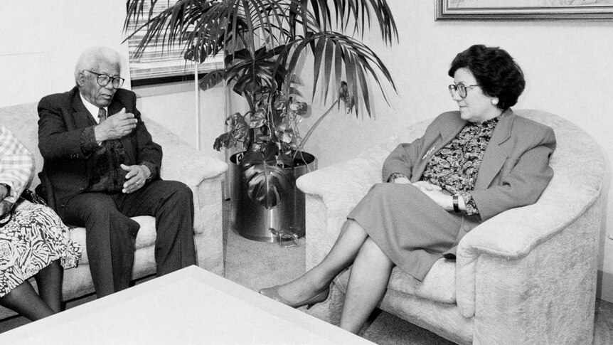 A black and white picture of Walter Sisulu and a woman with WA Premier Carmen Lawrence in a room.