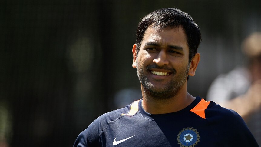 Indian captain MS Dhoni smiling at training