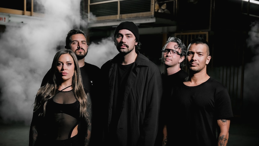 Australian metal group Make Them Suffer look at the camera with a smoky background
