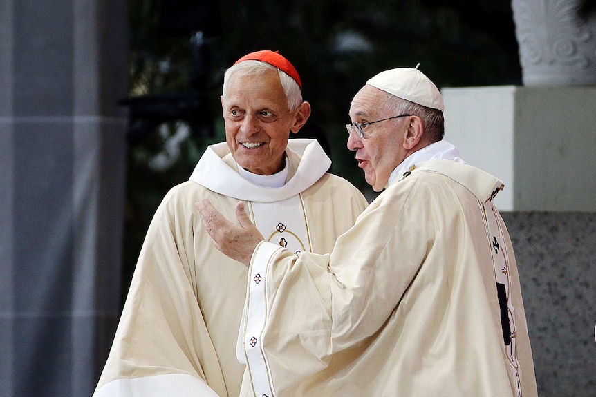 Cardinal Wuerl stands smiling next to Pope Francis.