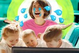 Photograph of a mum sitting behind three small children watching TV, the mum with exaggerated cartoon tears around her face.