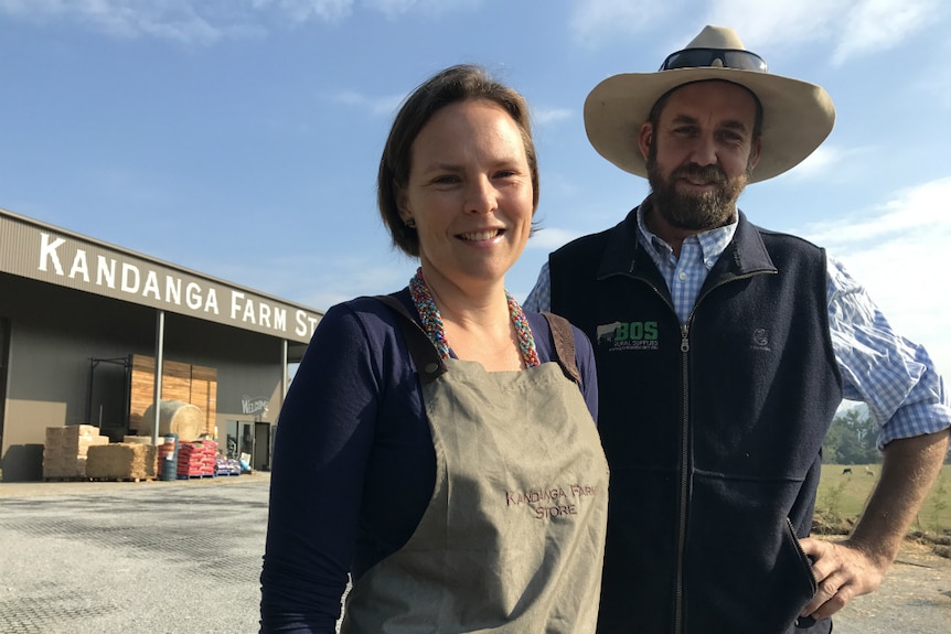 Tim and Amber Scott looking at the camera outside their new Kandanga Farm store shed.