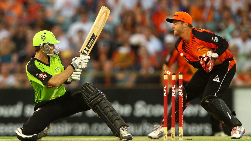 Cameron Borgas of the Sydney Thunder is bowled by Brad Hogg of the Perth Scorchers.