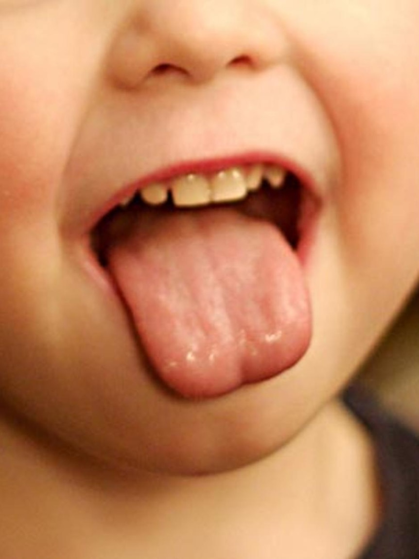 A child pokes out their tongue