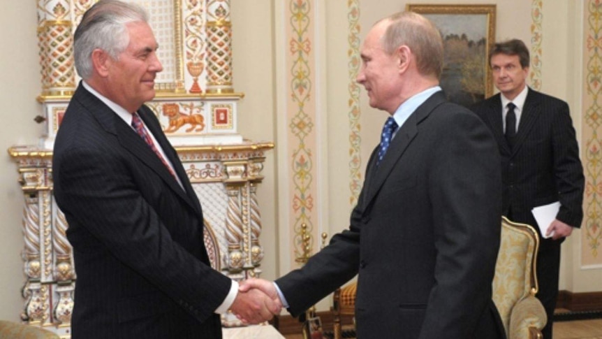 Exxon Mobil chairman and CEO Rex Tillerson shakes Russian President Vladimir Putin's hand