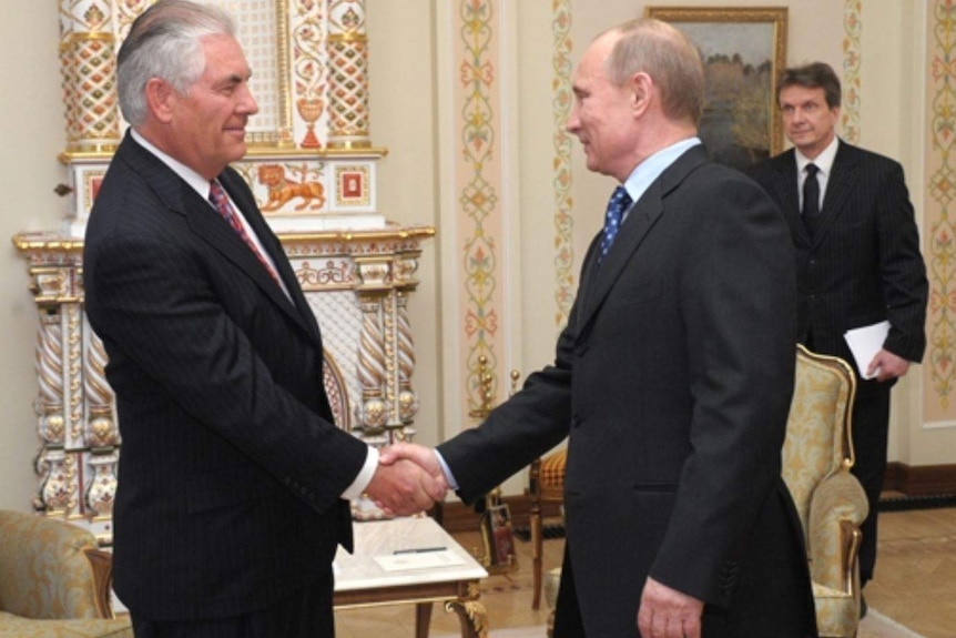 Exxon Mobil chairman and CEO Rex Tillerson shakes Russian President Vladimir Putin's hand