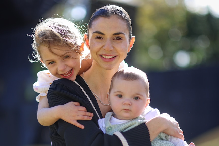 Eight-month-old Harrison McLaren with his four-year-old sister Lara and mum Jessica