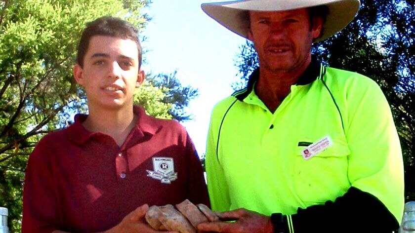 Raymond Hodgson and Ben Smith hold a piece of Icthyosaur vertebrae