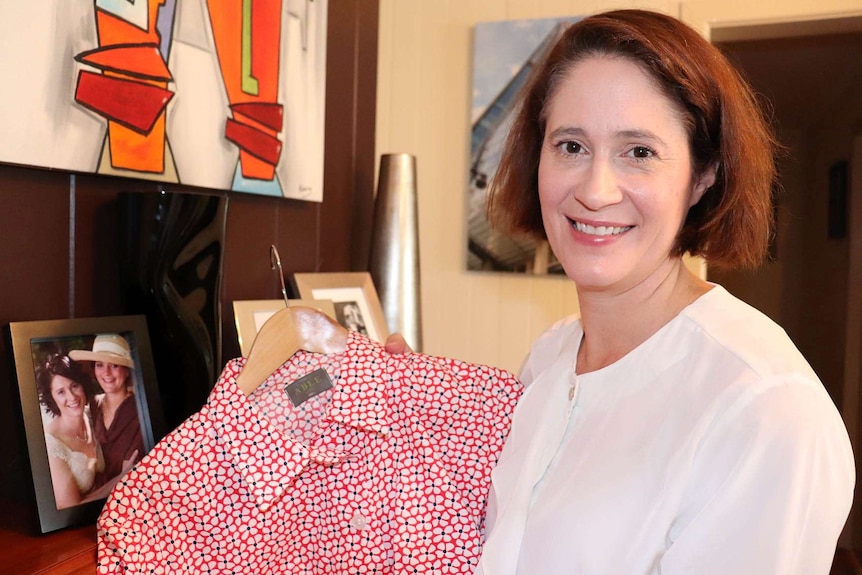 Hello Yello Clothing's founder Charlotte Coory holds a shirt