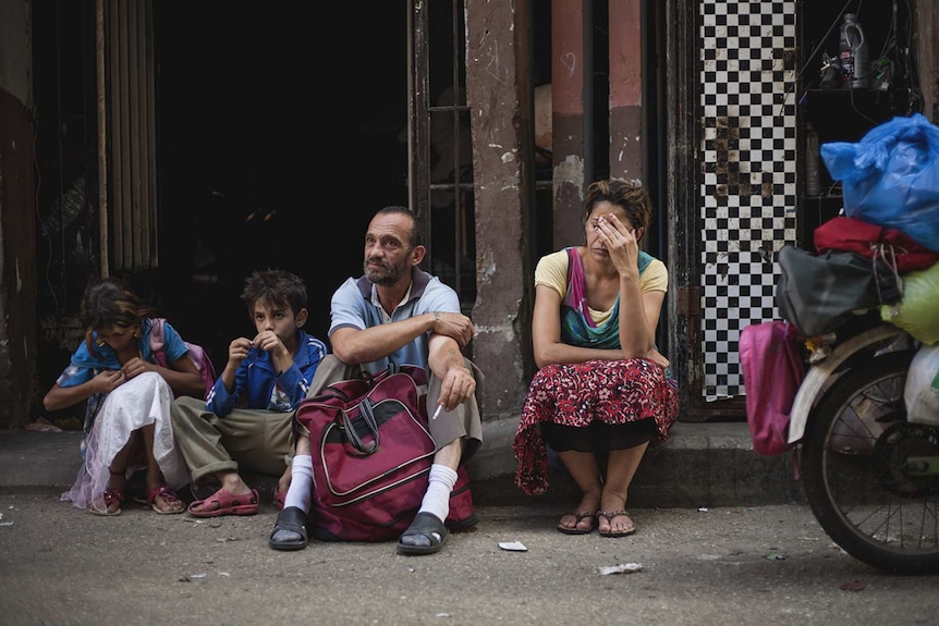 Colour photo of Haita 'Cedra' Izam, Zain Al Rafeea, Fadi Kamel Youssef and Kawthar Al Haddad Bankole in 2018 film Capharnaüm.