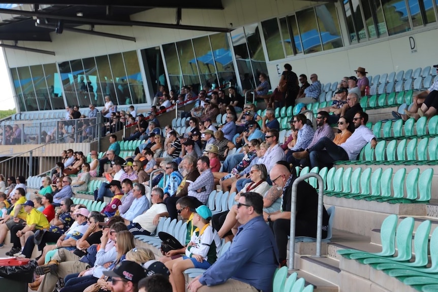 people sitting in grand stands