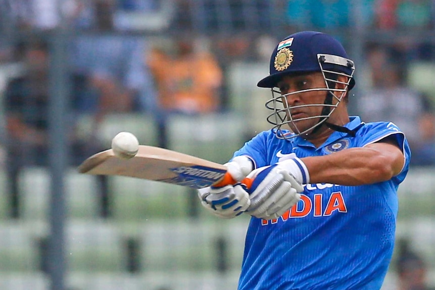 Indian cricket captain Mahendra Singh Dhoni plays a shot during the third one-day international cricket match against Bangladesh