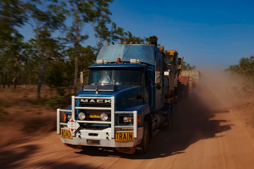 The truck picks up speed over a smoother section of the road