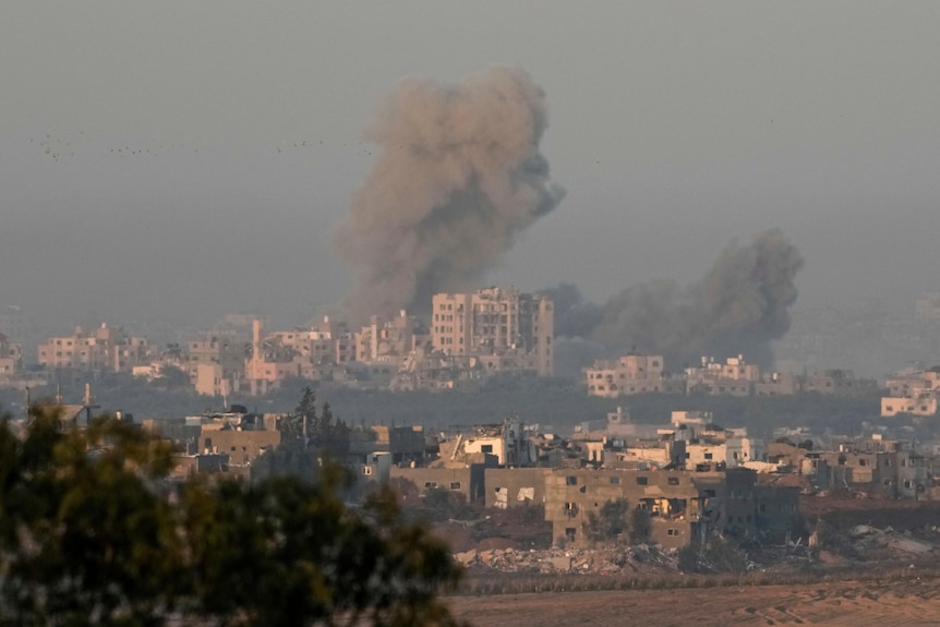 Smoke rises over buildings in the Gaza strip, as seen from Israel
