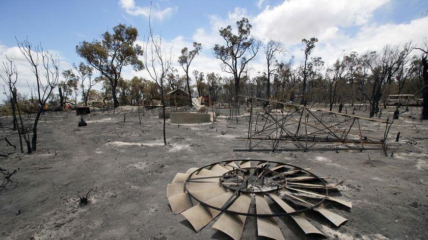 A windmill lies on the scorched ground after the fire last December