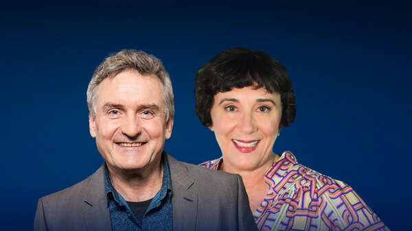 Richard Glover and Sarah Macdonald are smiling in front of a blue background