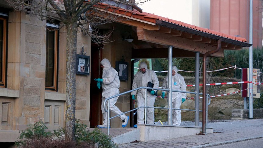 Forensic experts enter a house where a shooting took place, in Rot am See, Germany.