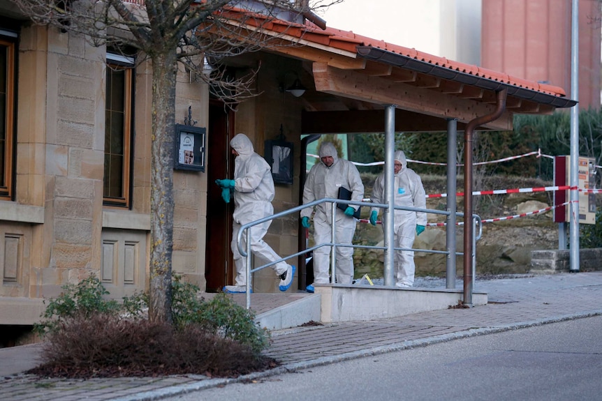 Forensic experts enter a house where a shooting took place, in Rot am See, Germany.