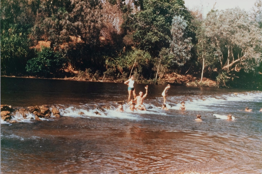 People are seen swimming in the Daly River.