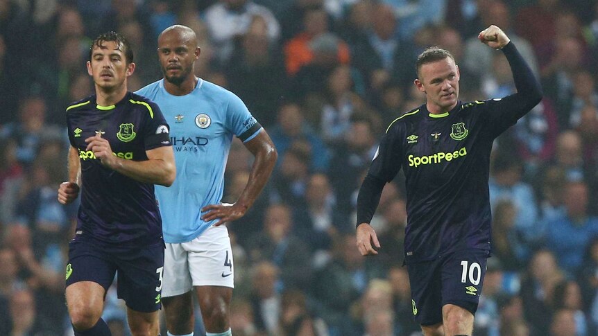 Wayne Rooney pumps his fist after scoring against Manchester City