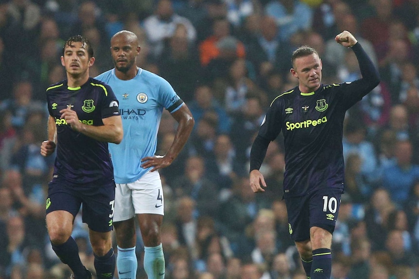 Wayne Rooney pumps his fist after scoring against Manchester City