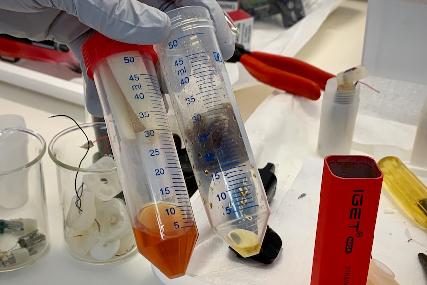 Two vials of liquid show the vape research being done at the Forensic and Scientific Services lab