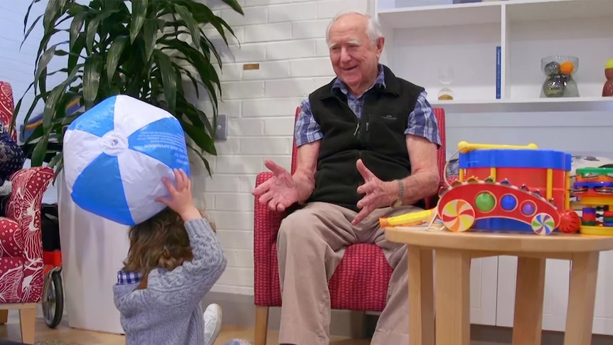 Older man and child playing with ball to promote ABC iview's Ageless Friendships