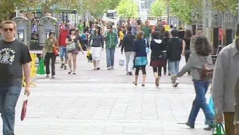 Shoppers make their way into the city.