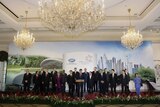 Singapore's Prime Minister Lee Hsien Loong (front row C) speaks surrounded by APEC leaders