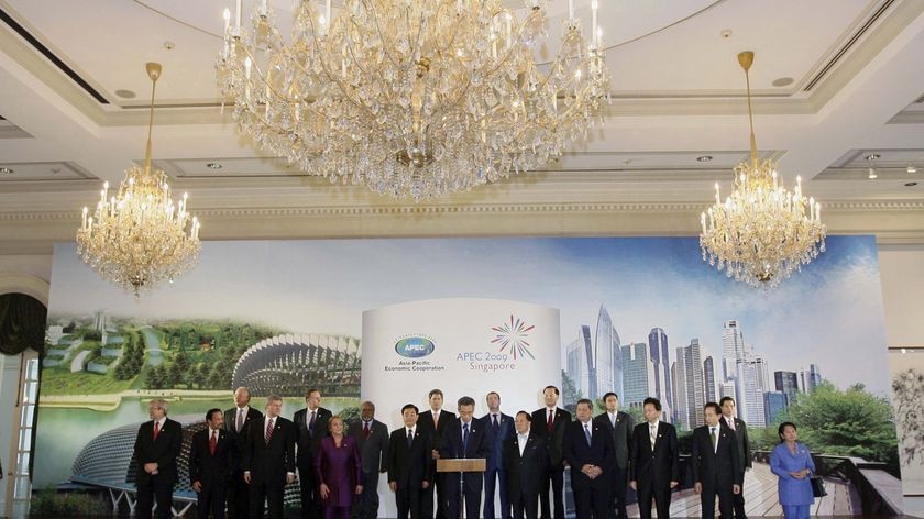 Singapore's Prime Minister Lee Hsien Loong (front row C) speaks surrounded by APEC leaders