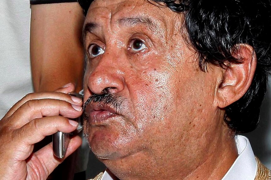 Abdelati Obeidi makes a phone call after his arrest.