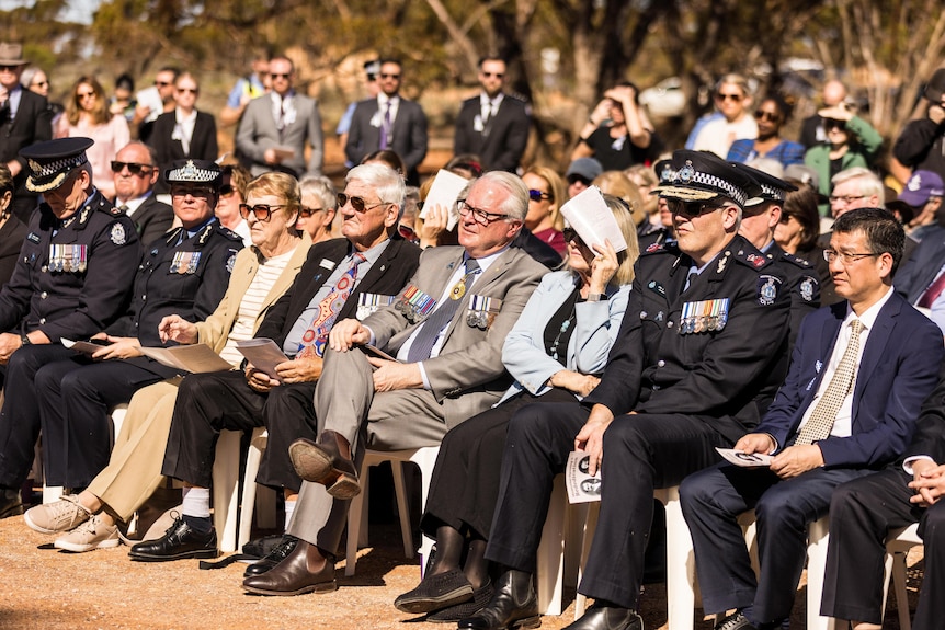 Dignitaries at a unveiling ceremony for a police memorial.  