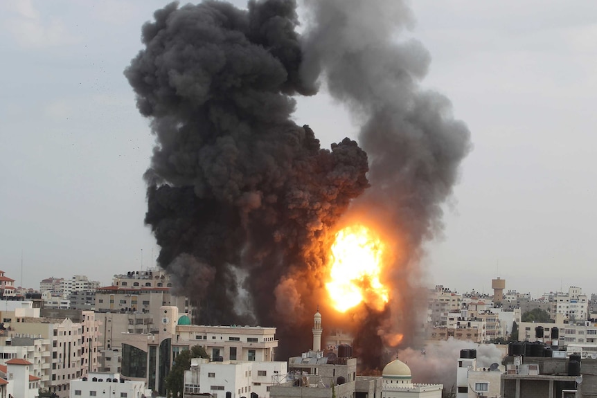 An explosion and smoke are seen after Israeli strikes in Gaza City
