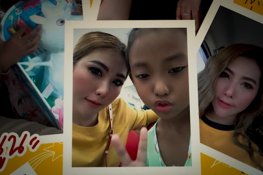 A close up of one of two girls smiling in a polaroid photo.