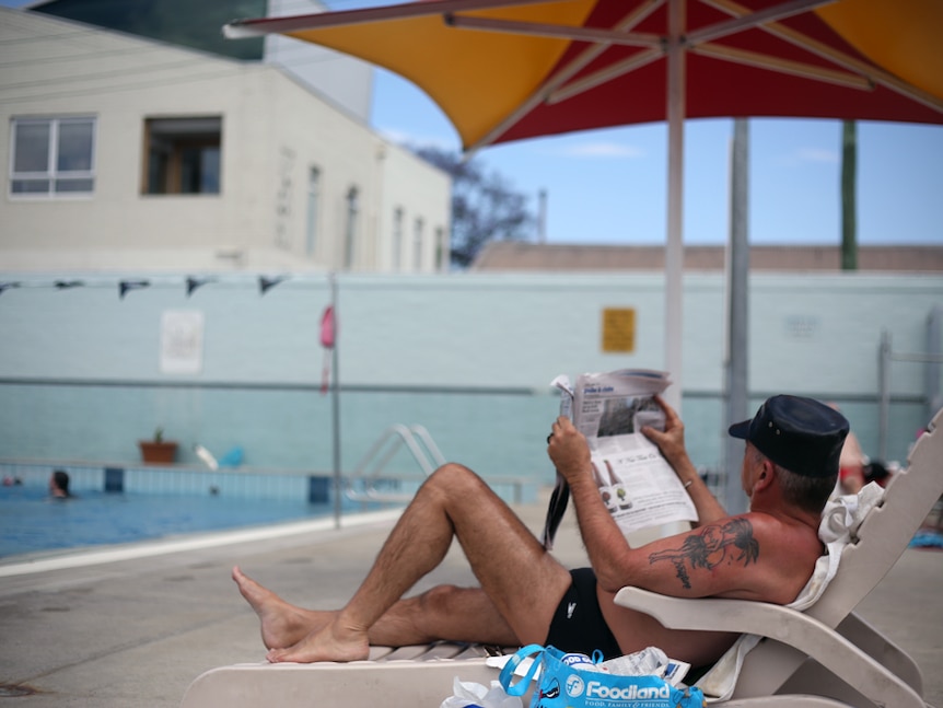 Melbourne man Simon relaxes by the Fitzroy Swimming Pool.