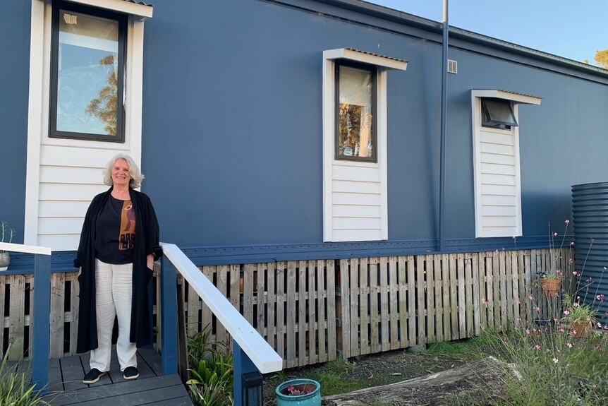 woman standing in front of tiny home