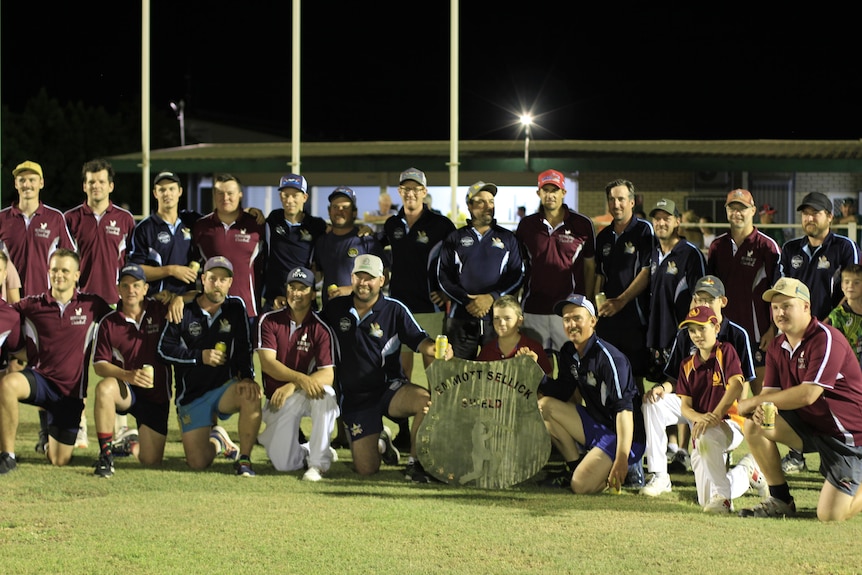 Two cricket teams hand in hand following a grand final match